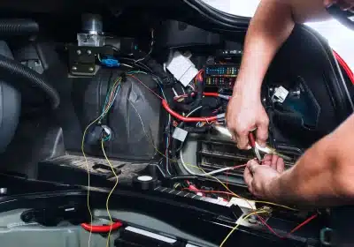 a close-up of a man working on a car