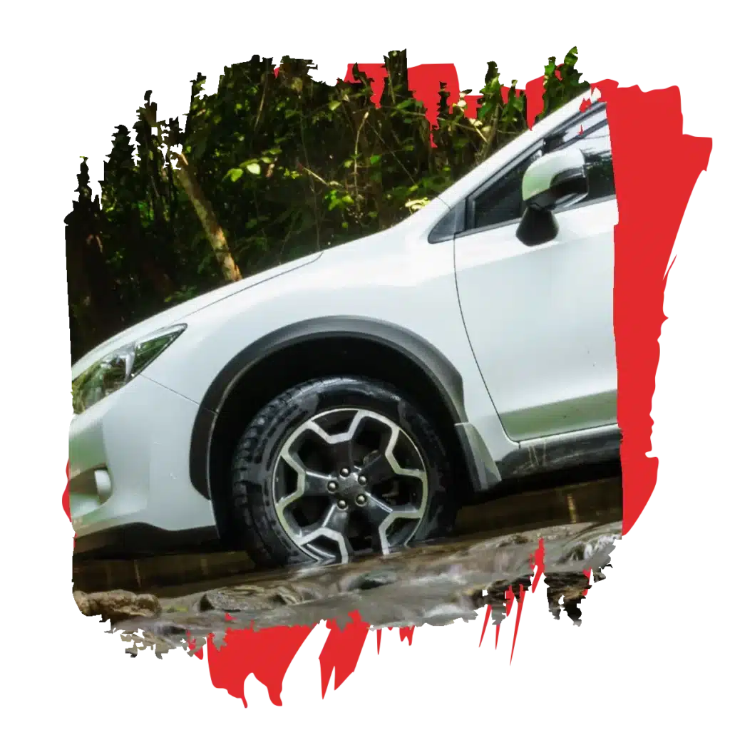 a white car parked on a muddy road