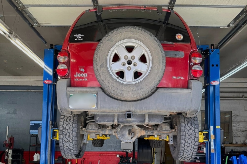 Scheduled Car Maintenance in Durango, CO At Firestone of Durango. Vehicle lifted in auto repair shop for scheduled maintenance