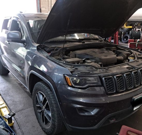 Finance Your Auto Repairs in Durango, CO At Firestone of Durango. Vehicle with open hood inside an auto repair shop.