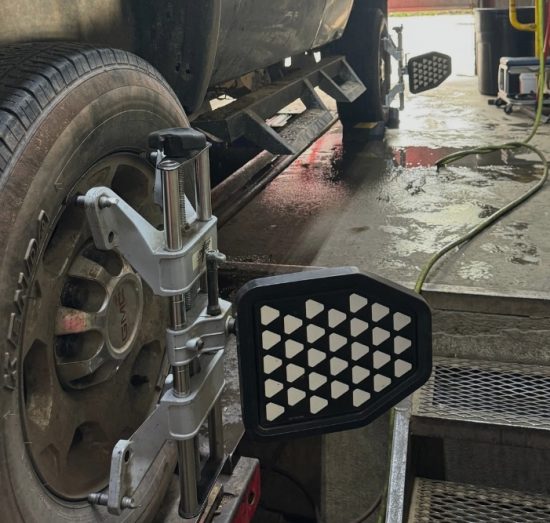 Wheel Alignment In Durango CO At Firestone of Durango. Close-up view of a vehicle during a wheel alignment service.