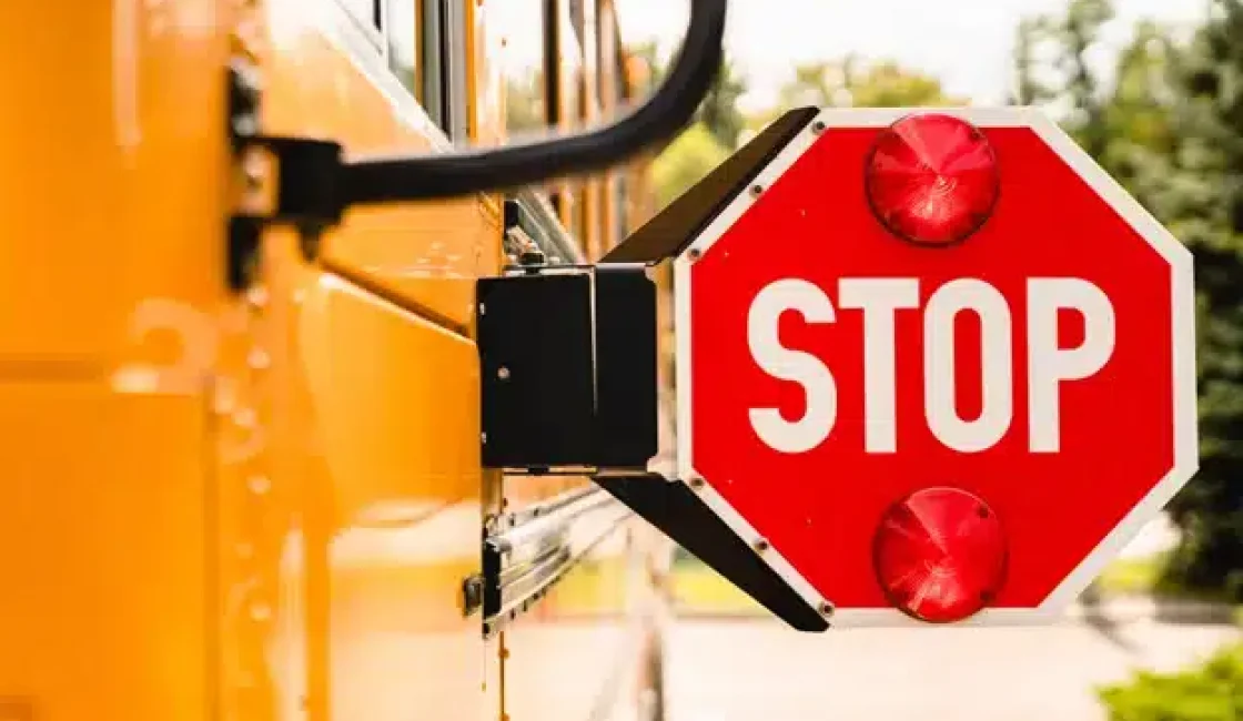 Prepare your vehicle for back to school traffic with Firestone of Durango in Durnago, CO. Image of a yellow school bus stop sign.